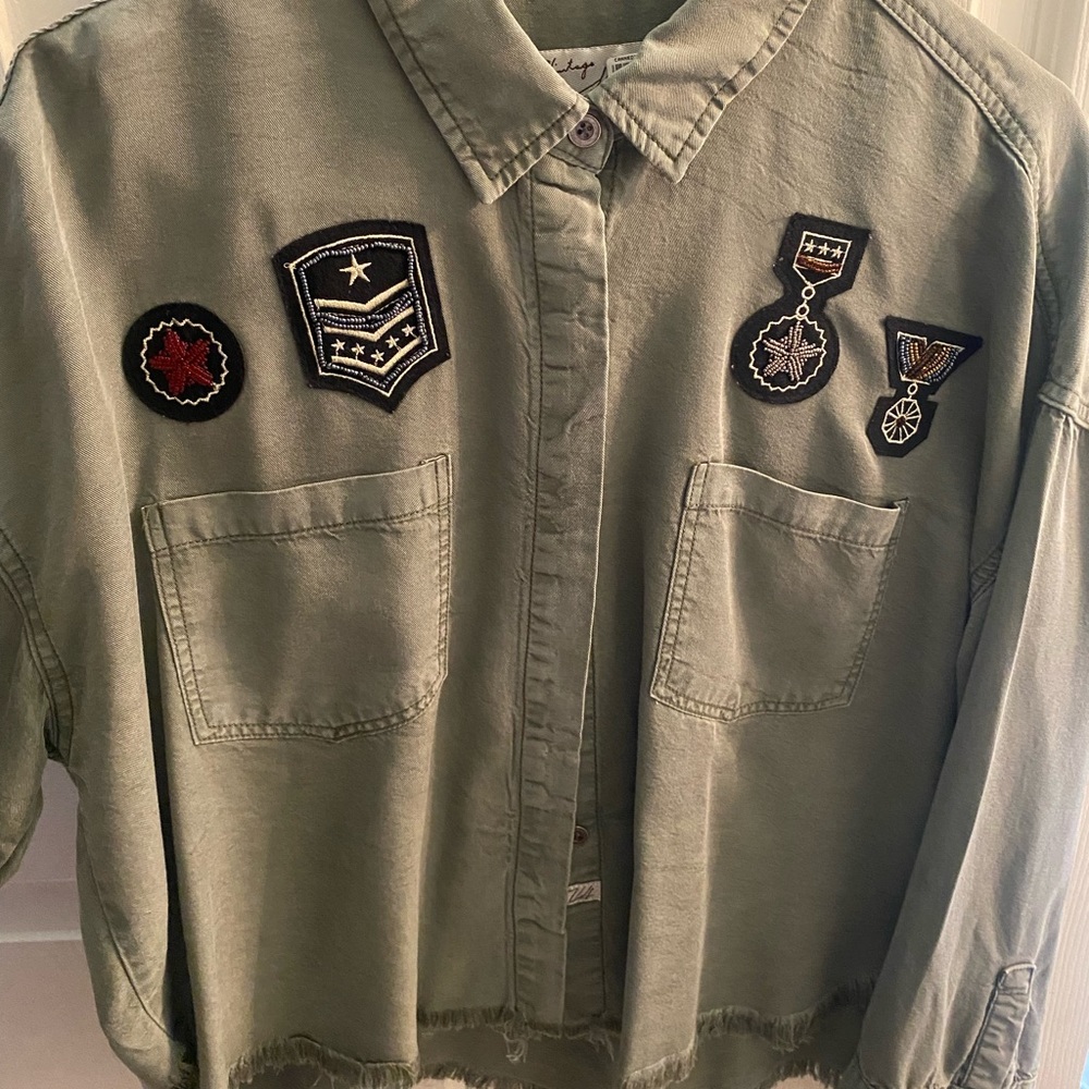 Green shirt/jacket with military patch detail and distressed bottom